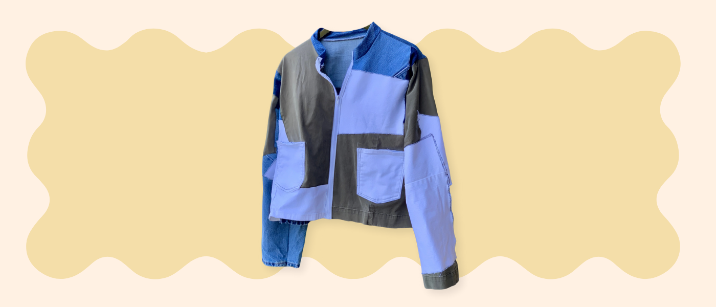 Blue jacket with black accents on a beige background