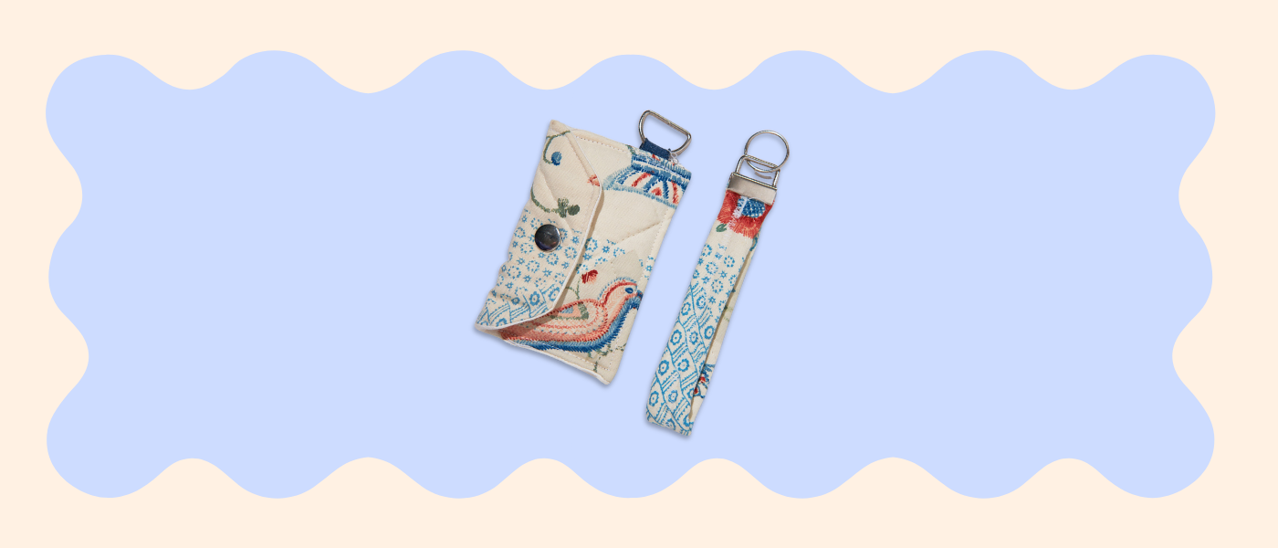 Two fabric straps with decorative patterns on a light blue and beige background