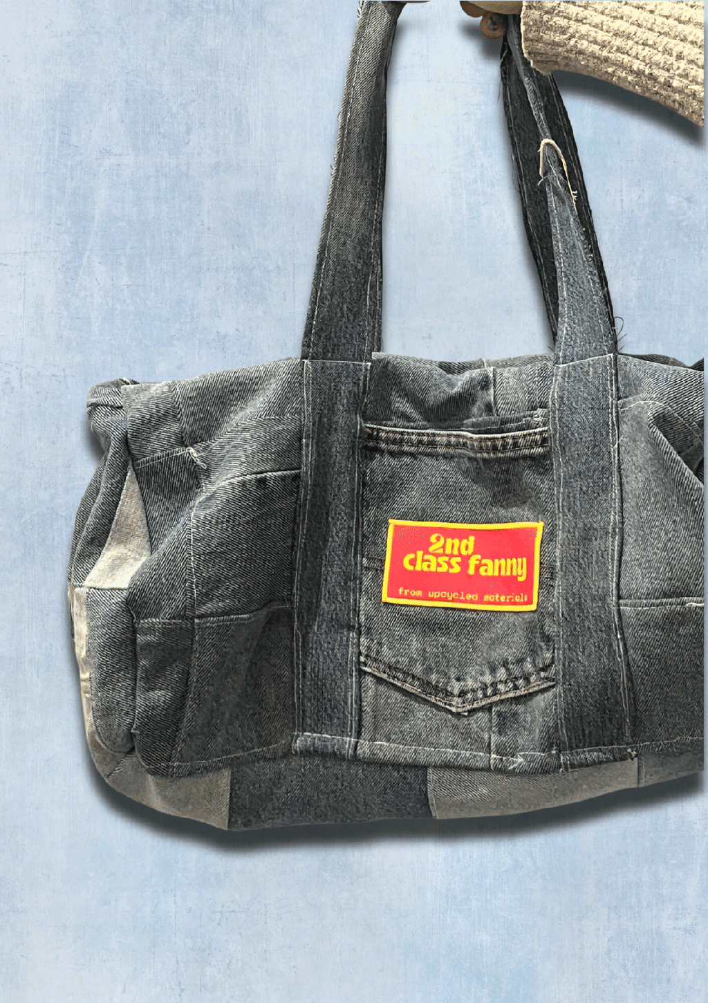 Denim bag with a visible brand label on a light blue background