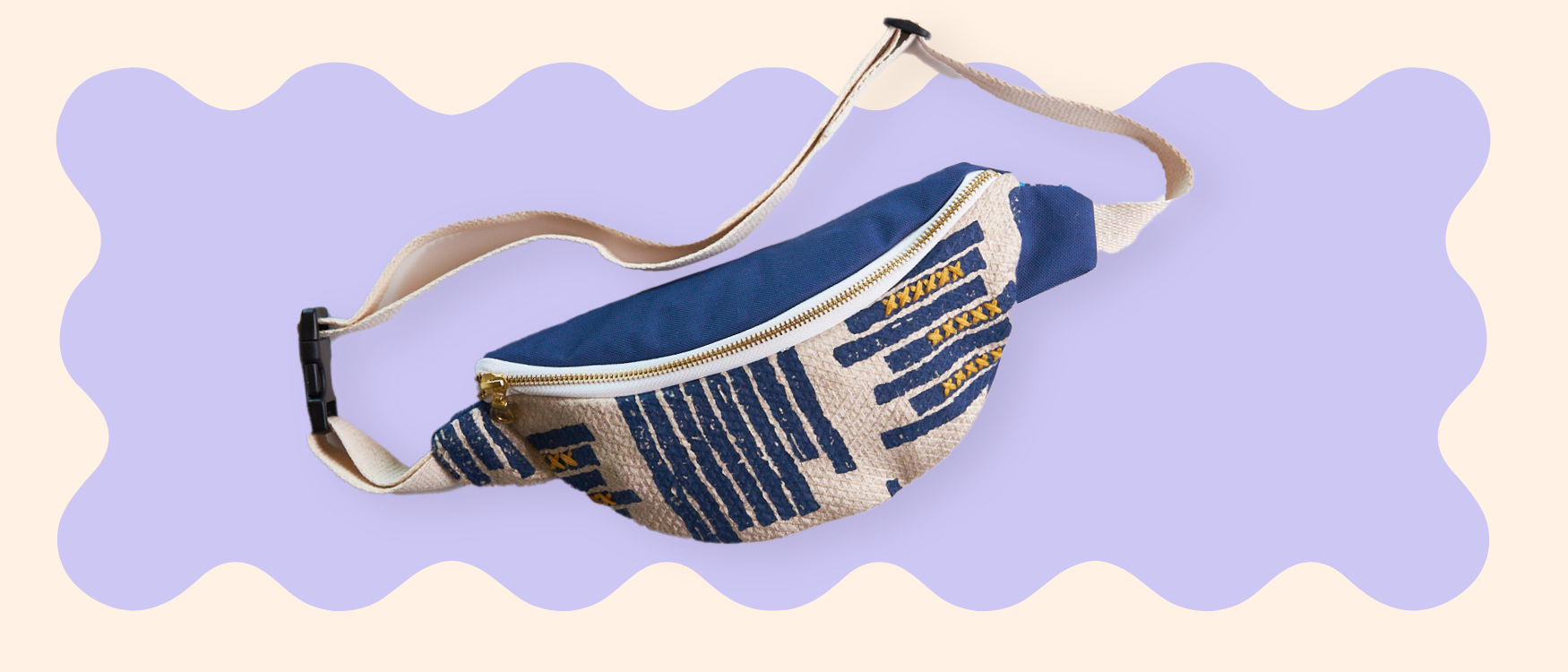 Blue and white patterned fanny pack on a light purple background