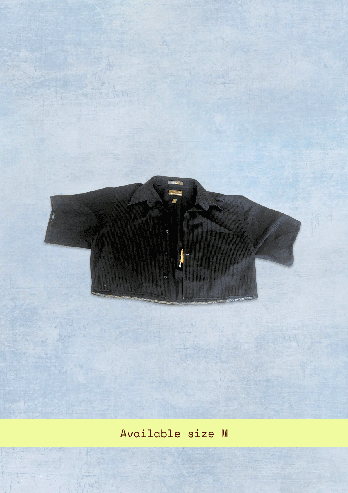 Black crop shirt upcycled from dress shirt on a light blue textured background with size M text.
