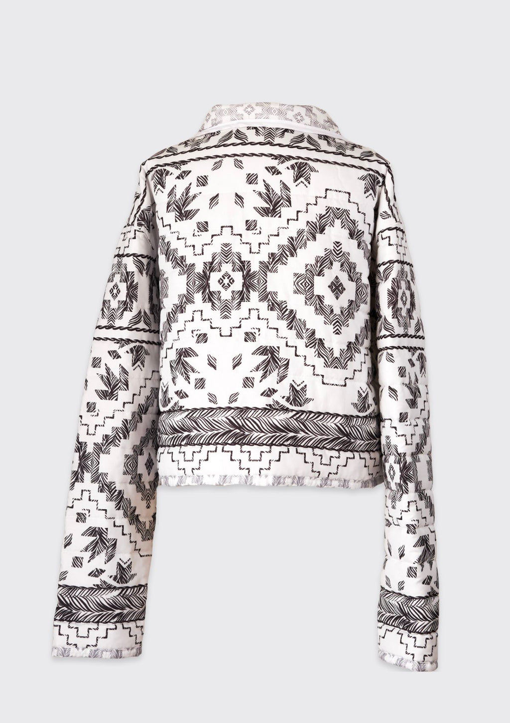 Black and white patterned jacket upcycled from a comforter on a light gray background