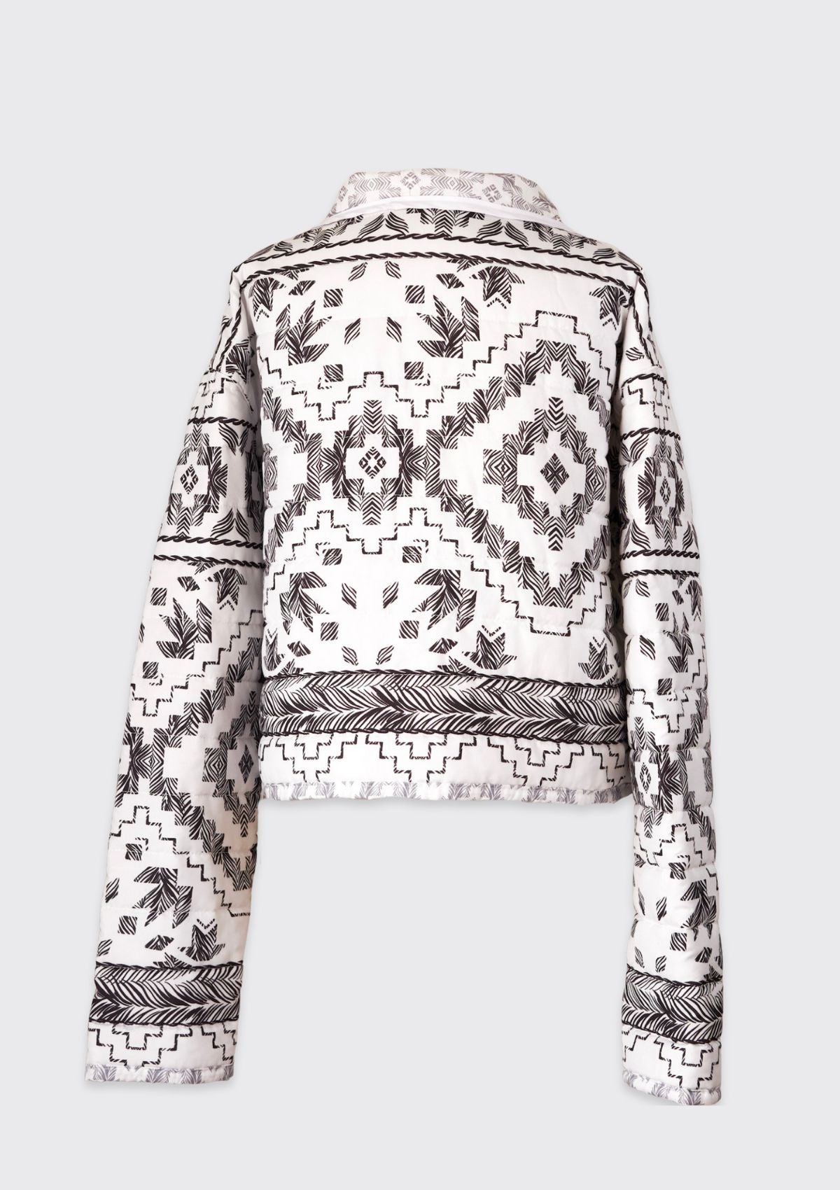 Black and white patterned jacket upcycled from a comforter on a light gray background