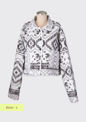 Black and white patterned jacket upcycled from a comforter on a mannequin against a white background