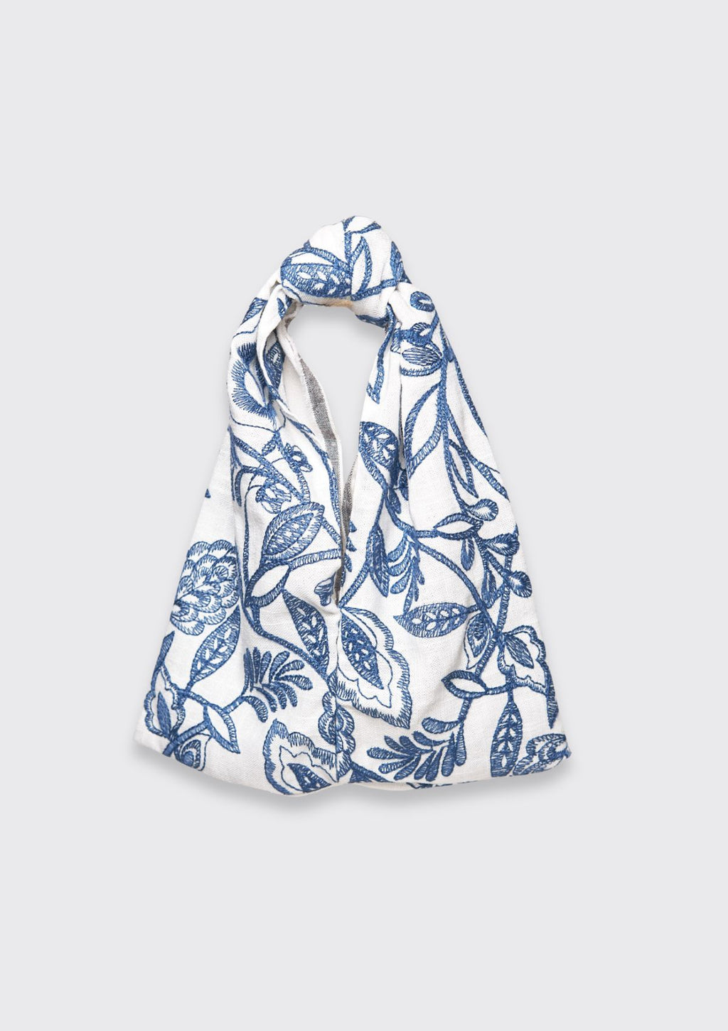 Blue floral patterned knot bag upcycled form designer deadstock fabric on a white background