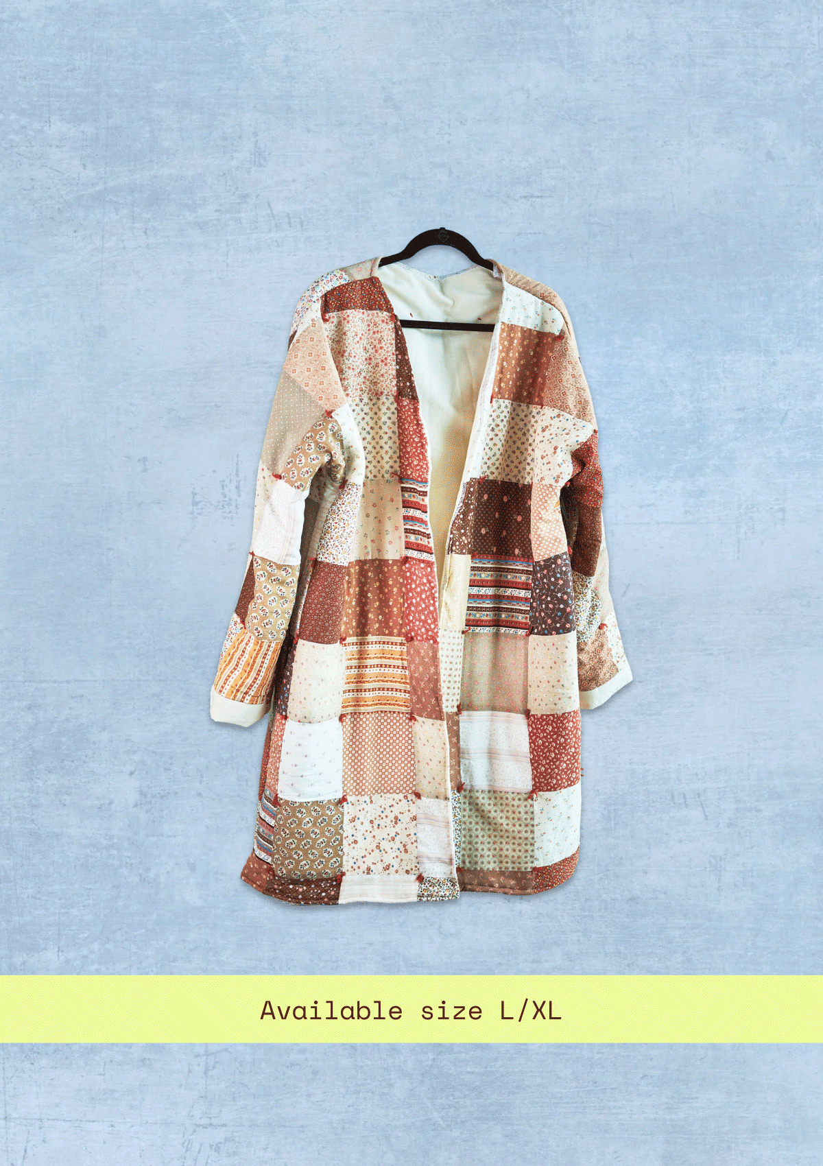 Patchwork coat on a hanger against a light blue background