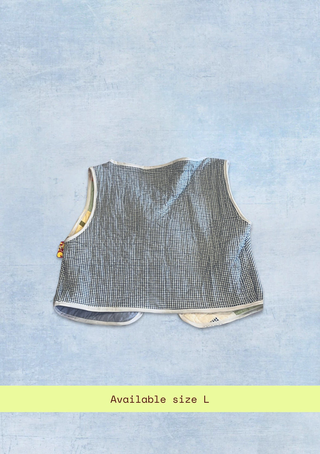 Textured sleeveless top upcycled from a quilt on a light blue background with 'Available size L' text.
