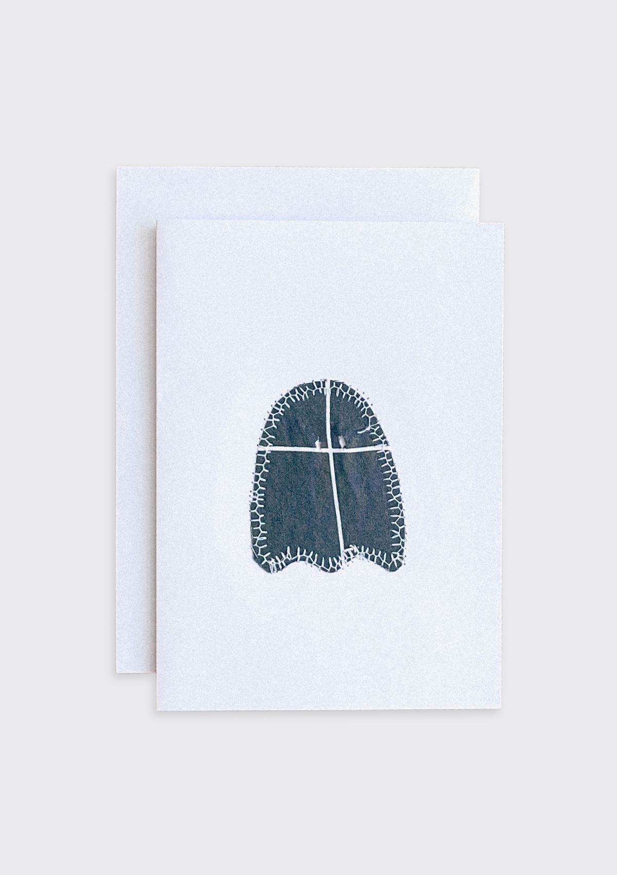 Black sewn ghost upcycled from quilt on a white card with a beige border