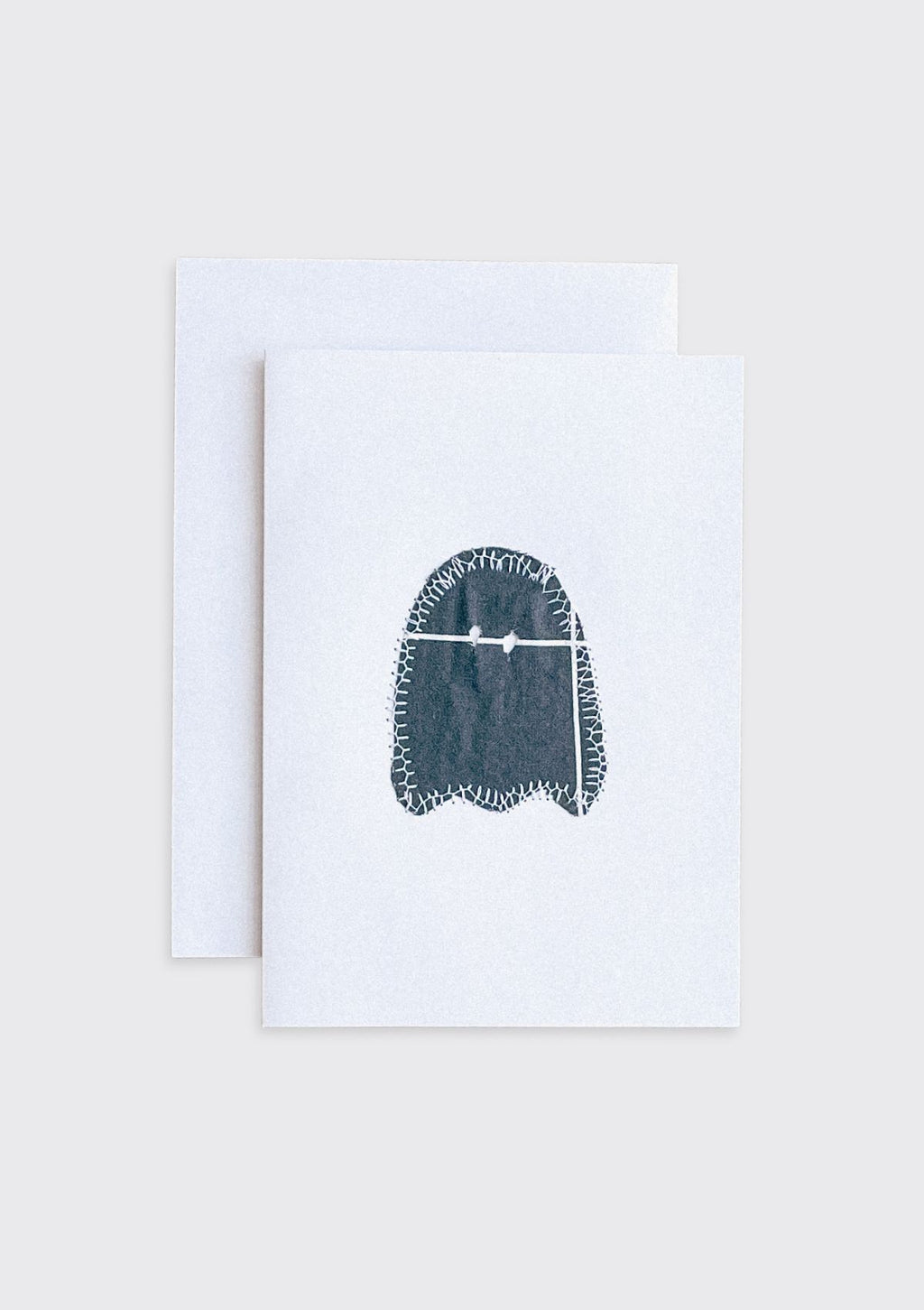 Black sewn ghost upcycled from quilt on a white card with a beige border