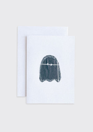 Black sewn ghost upcycled from quilt on a white card with a beige border