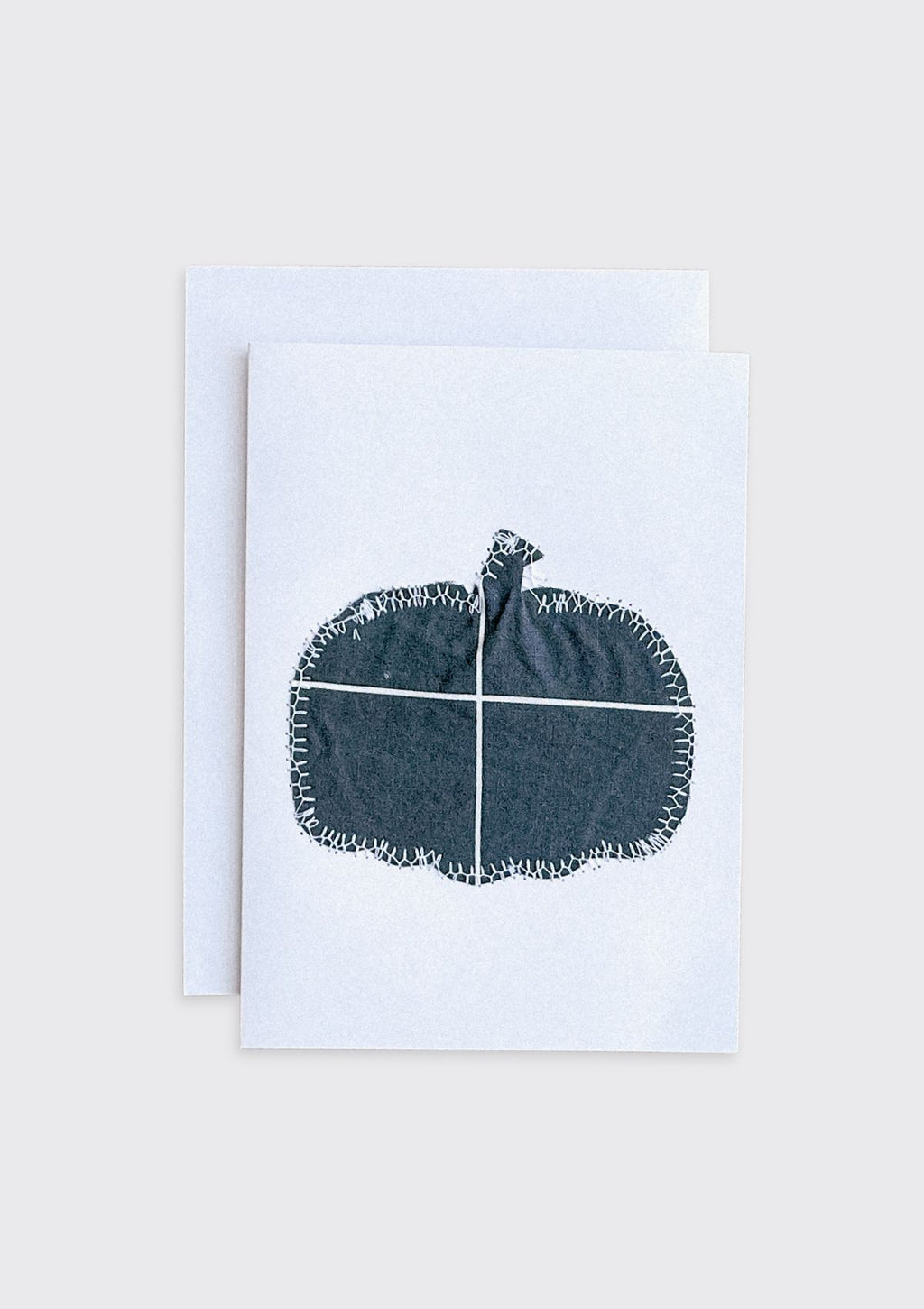 Greeting card with a black pumpkin design made from upcycled duvet cover on a white background