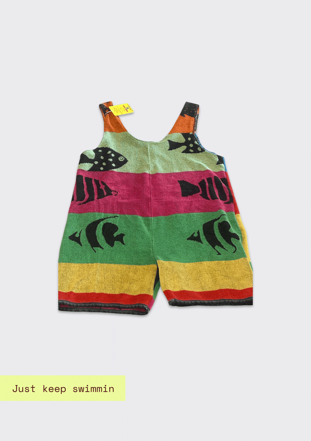 Colorful striped romper/jumper upcycled from a beach towel with fish design on a white background