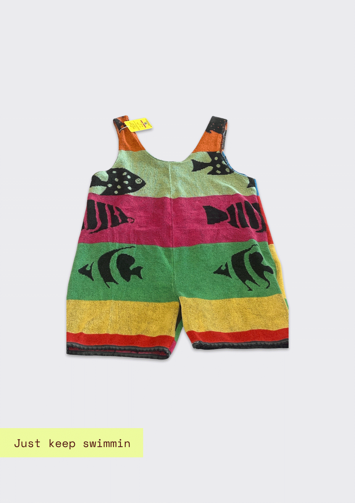 Colorful striped romper/jumper upcycled from a beach towel with fish design on a white background