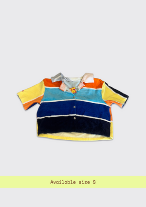 Colorful striped shirt upcycled from a beach towel on a light gray background