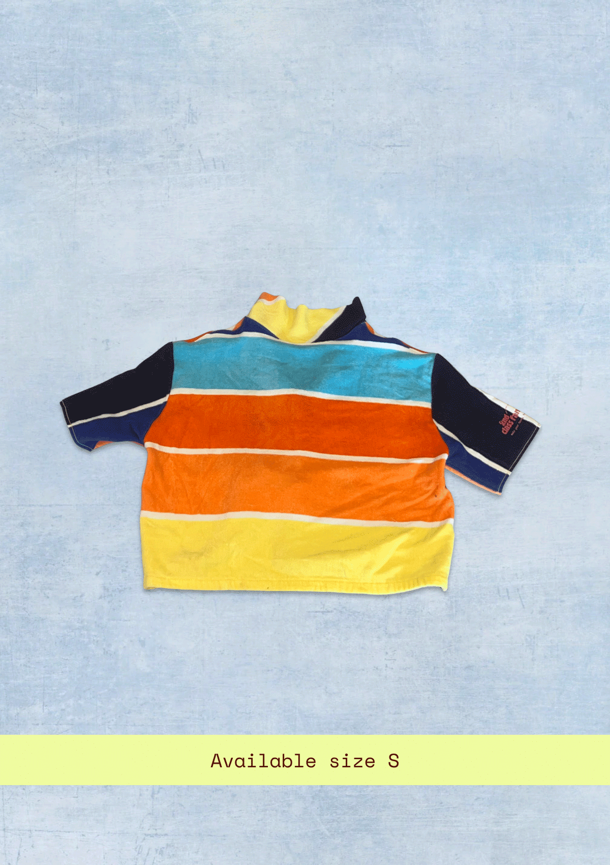 Colorful striped cropped shirt, upcycled from a beach towel on a light blue background with size S text.