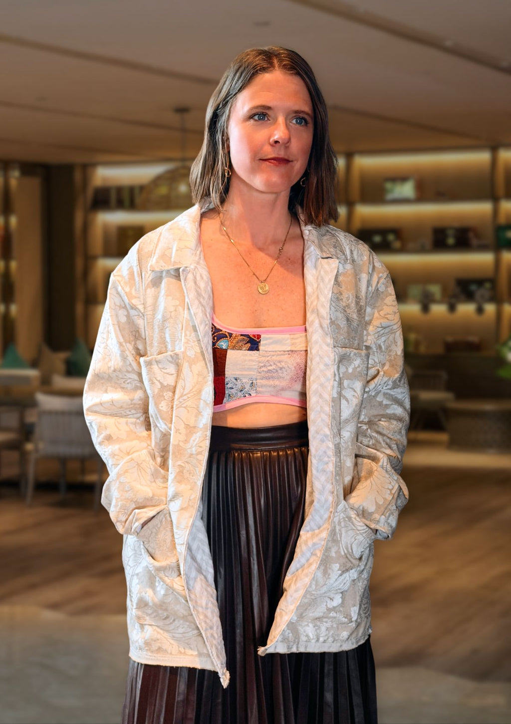 Woman wearing a patterned jacket from upcycled curtains in an indoor setting