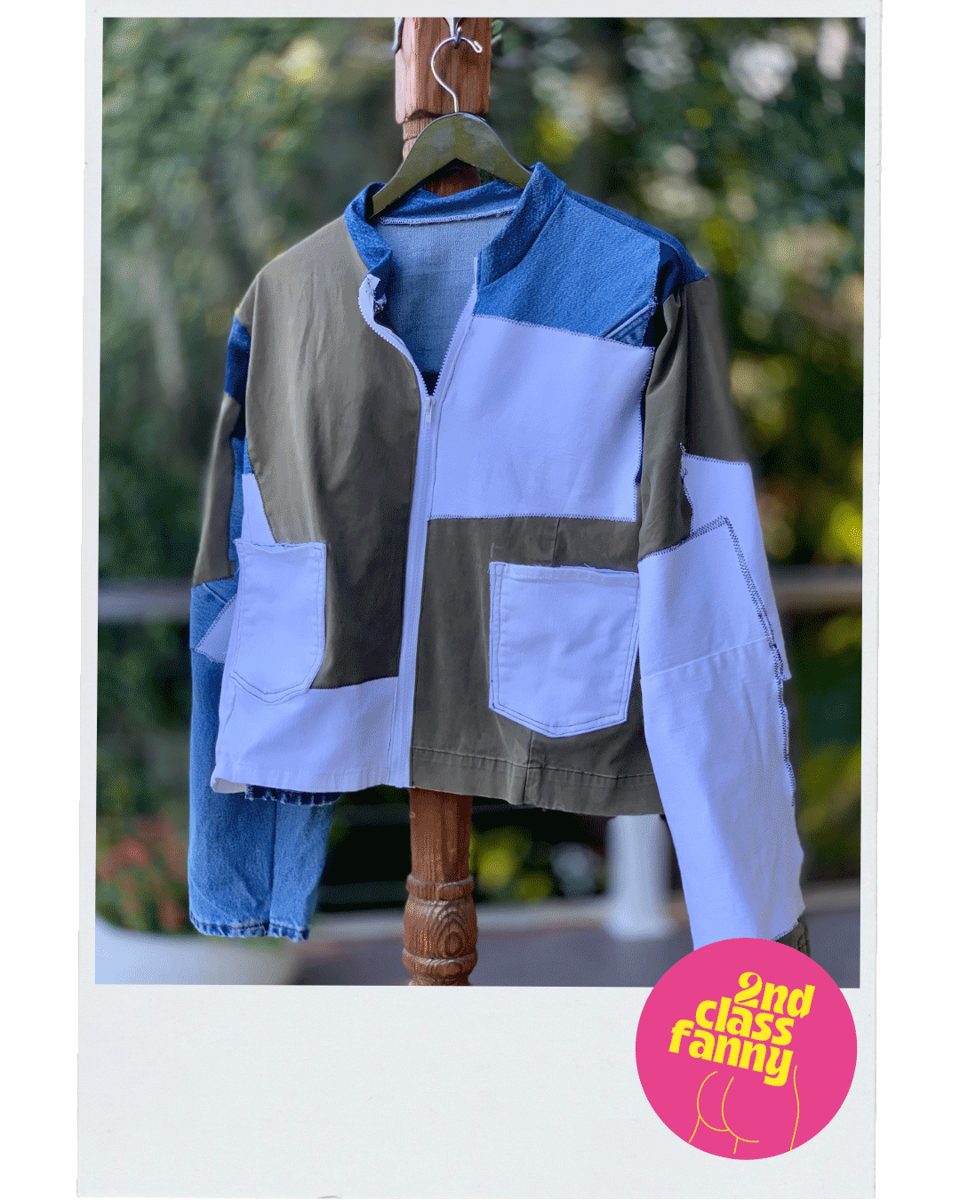 Multicolored jacket from upycycled denim in a patchwork layout on a hanger with a blurred outdoor background