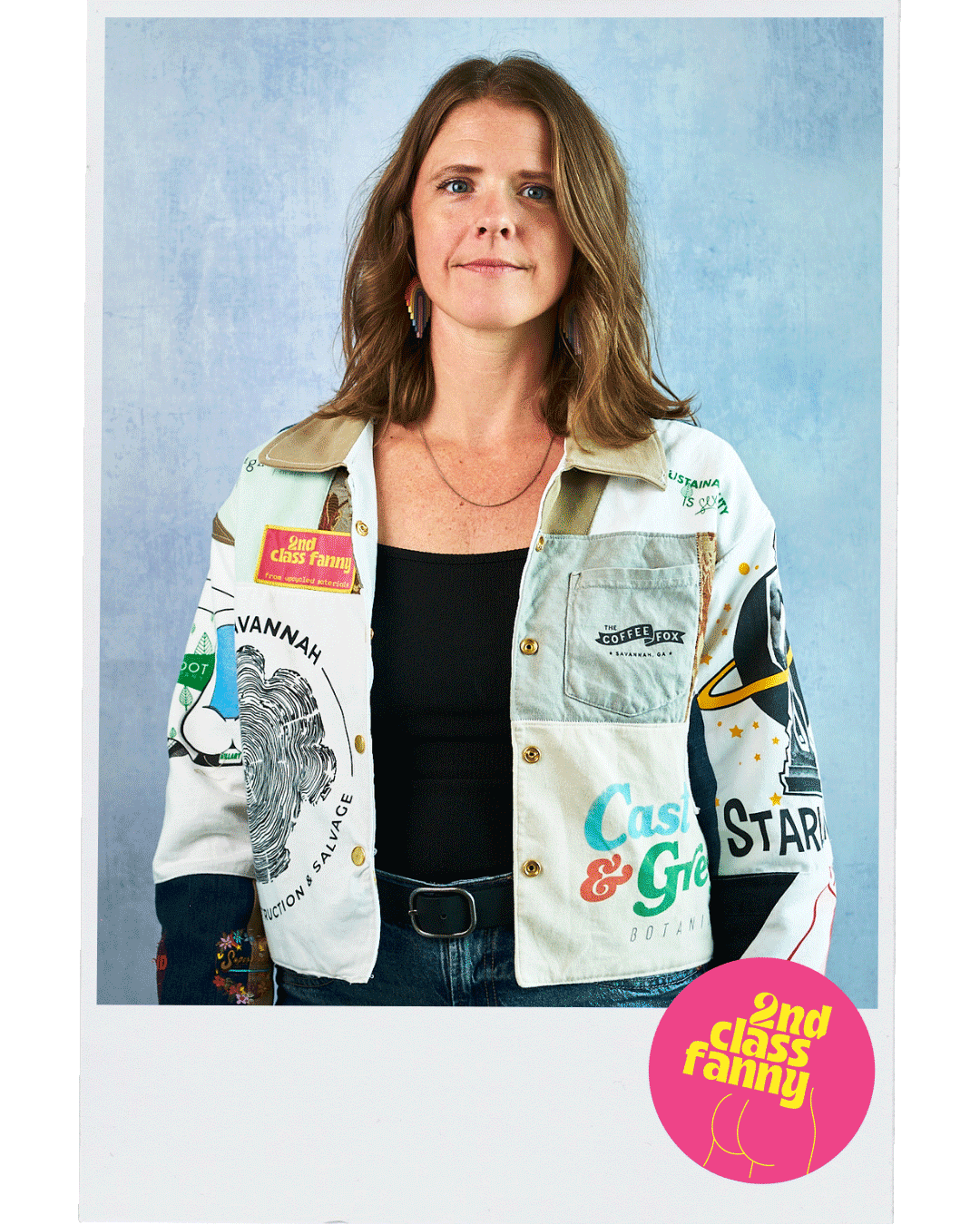 Woman wearing a colorful jacket with local Savannah business brand logos against a light blue background