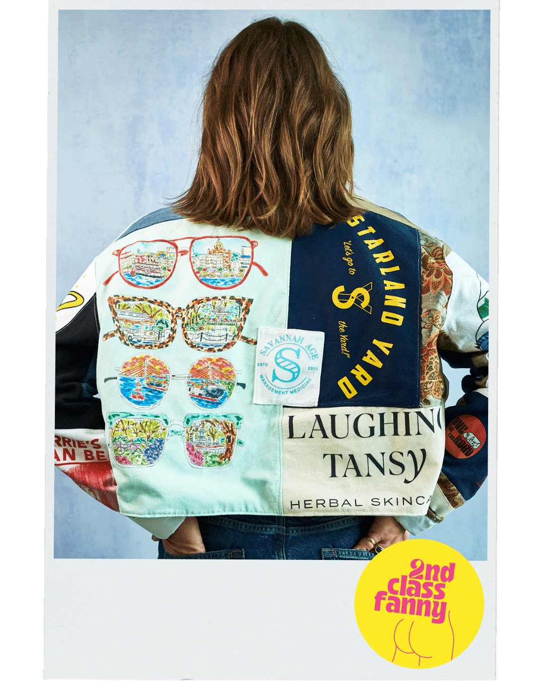Person wearing a colorful varsity jacket with various patches from logos of local Savannah small businesses.