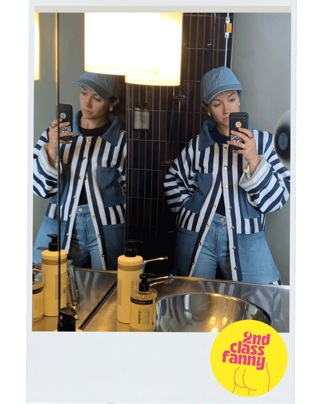 Person taking a mirror selfie wearing a striped jacket and blue jeans, with '2nd Class Family' logo in the corner.