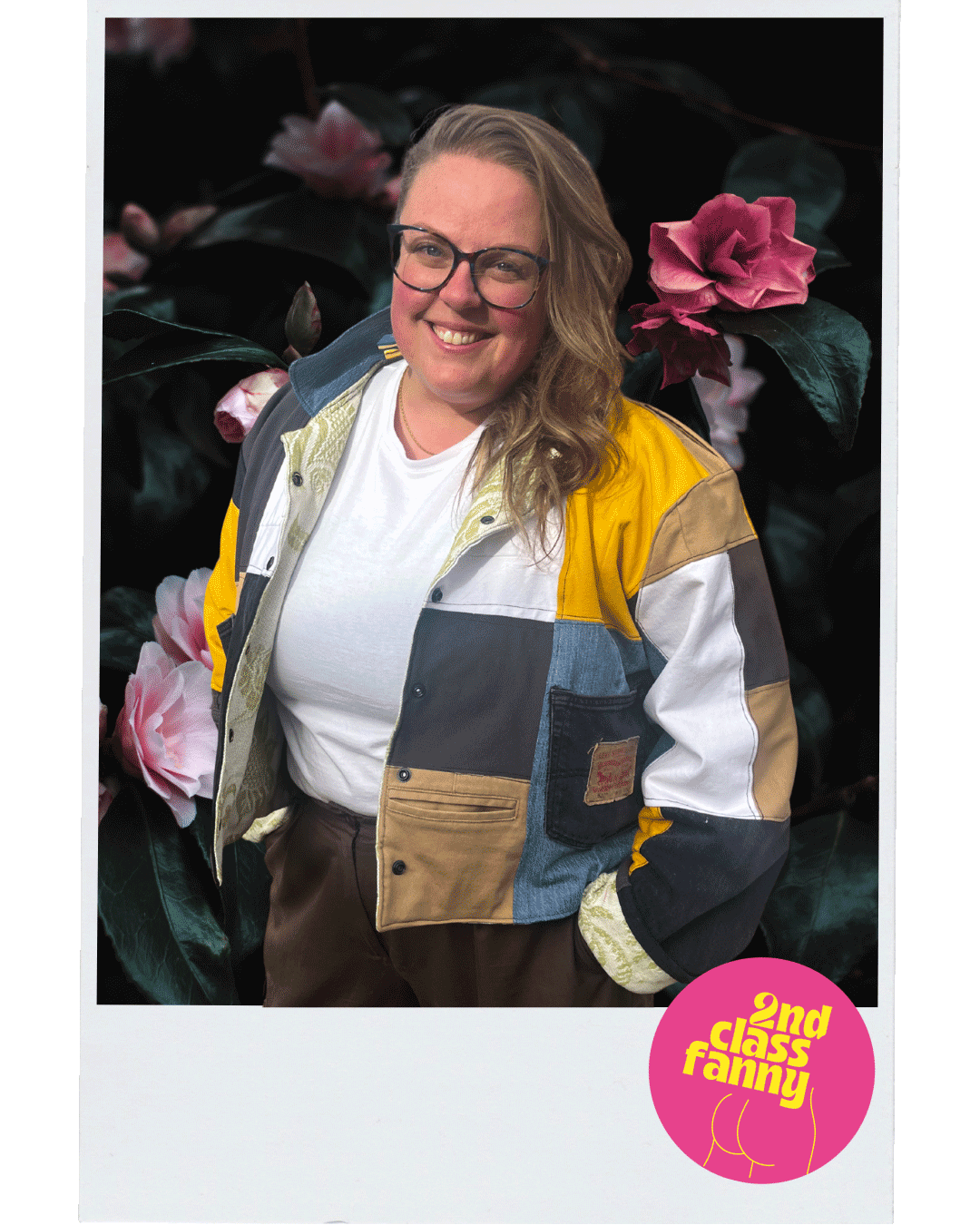 Person wearing a colorful jacket with flowers in the background, featuring 'Only Class Fanny' logo.