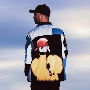 Person wearing a colorful jacket with a graphic design on the back against a blurred background