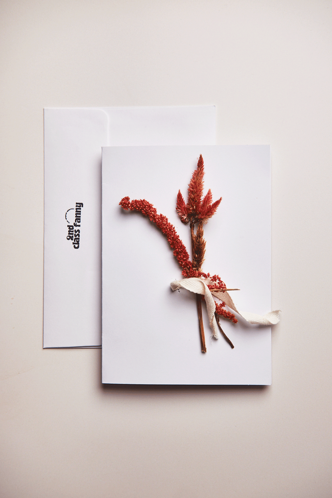 Greeting card with dried flowers on a white background