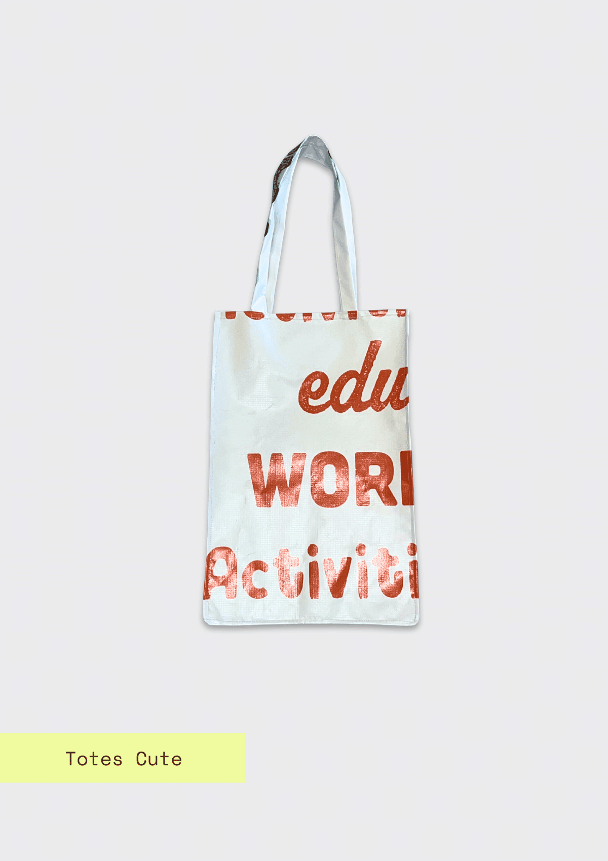 Tote bag with red letters pattern, upcycled from an Earth Day Banner on a light blue textured background with Totes Cute branding.