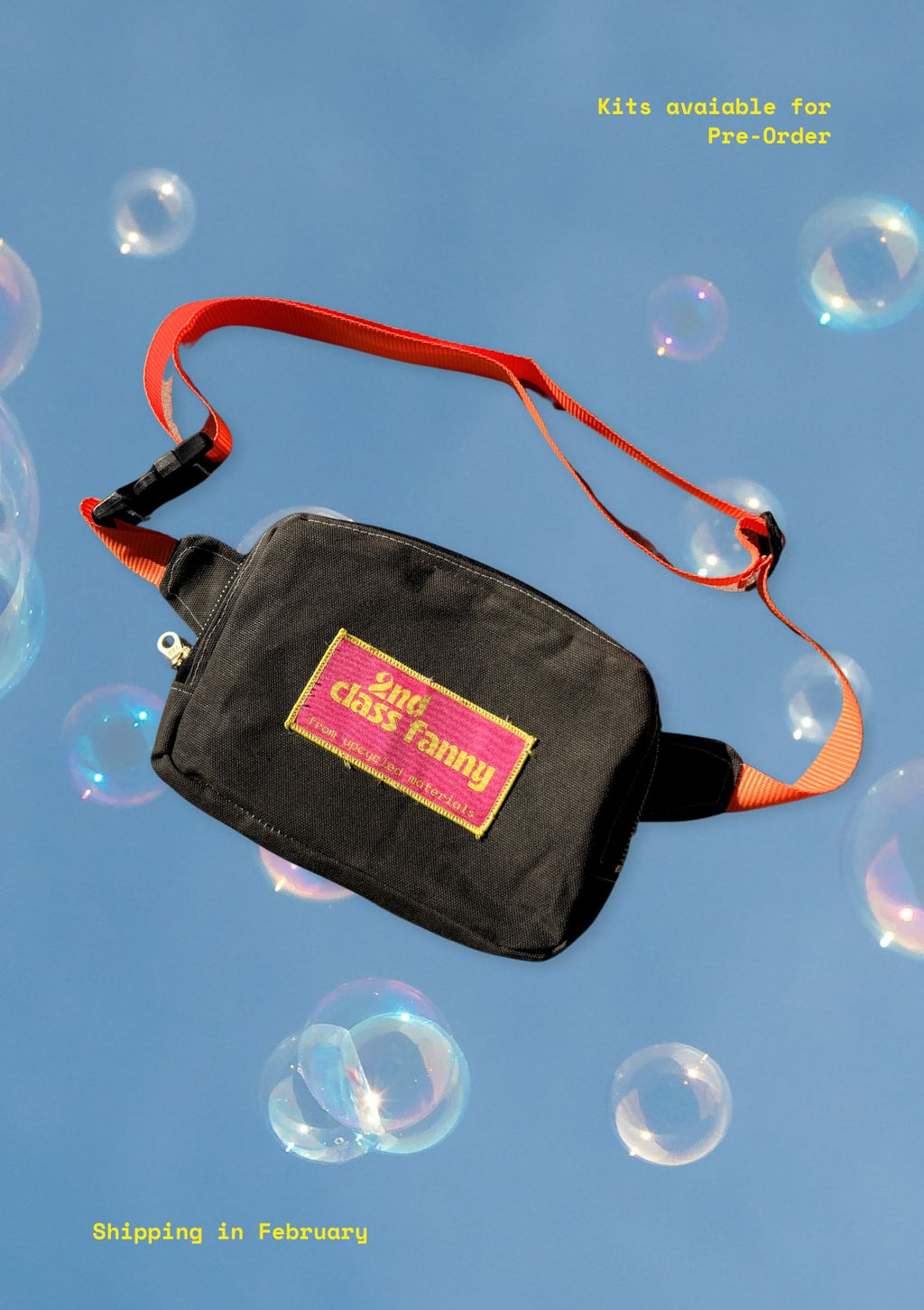 Black bag with red strap on a blue background with bubbles