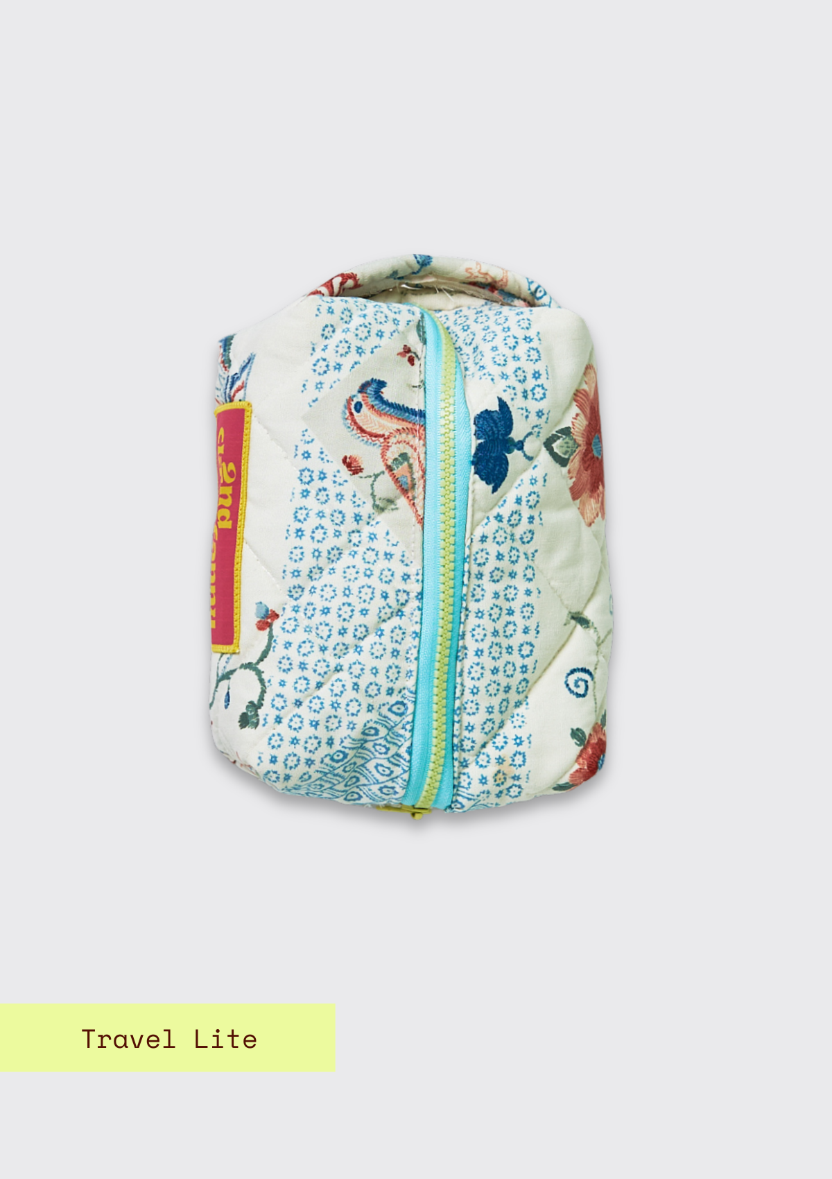 Small pouch / dobb kit with floral pattern upcycled from a quilt on a light gray background