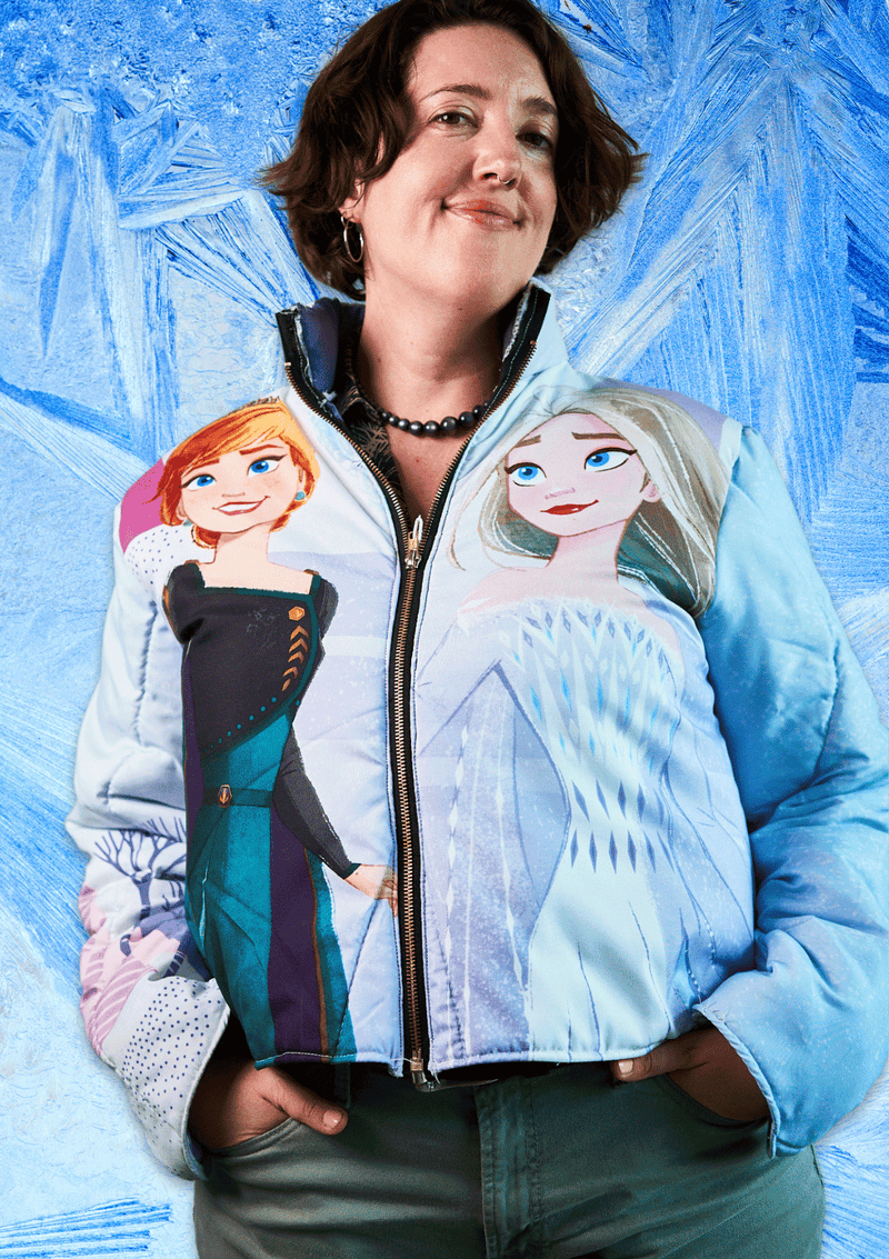 Person wearing a jacket with Frozen characters on a blue textured background
