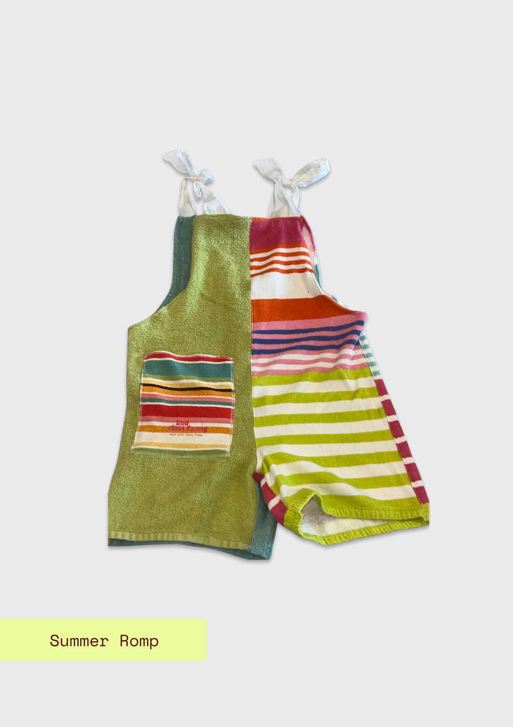 Colorful striped romper made from an upcycled beach towel on a light gray background with 'Summer Romp' text.