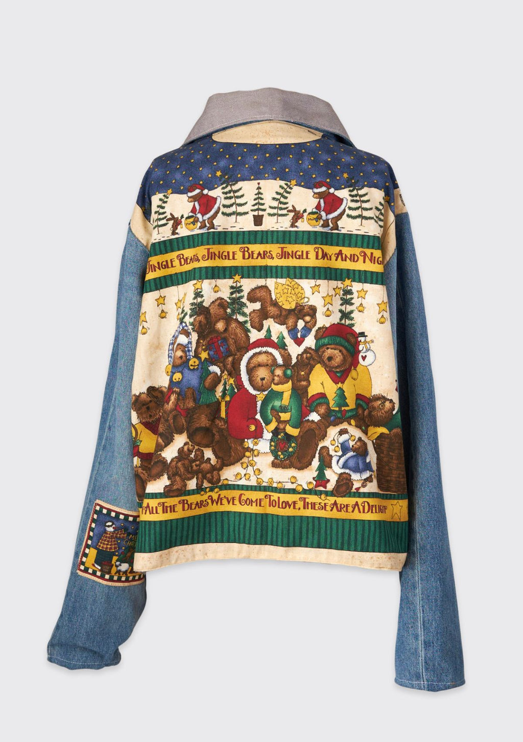 Colorful holiday jacket with bear-themed design upcycled from vintage fabric and denim jeans as sleeves on a white background