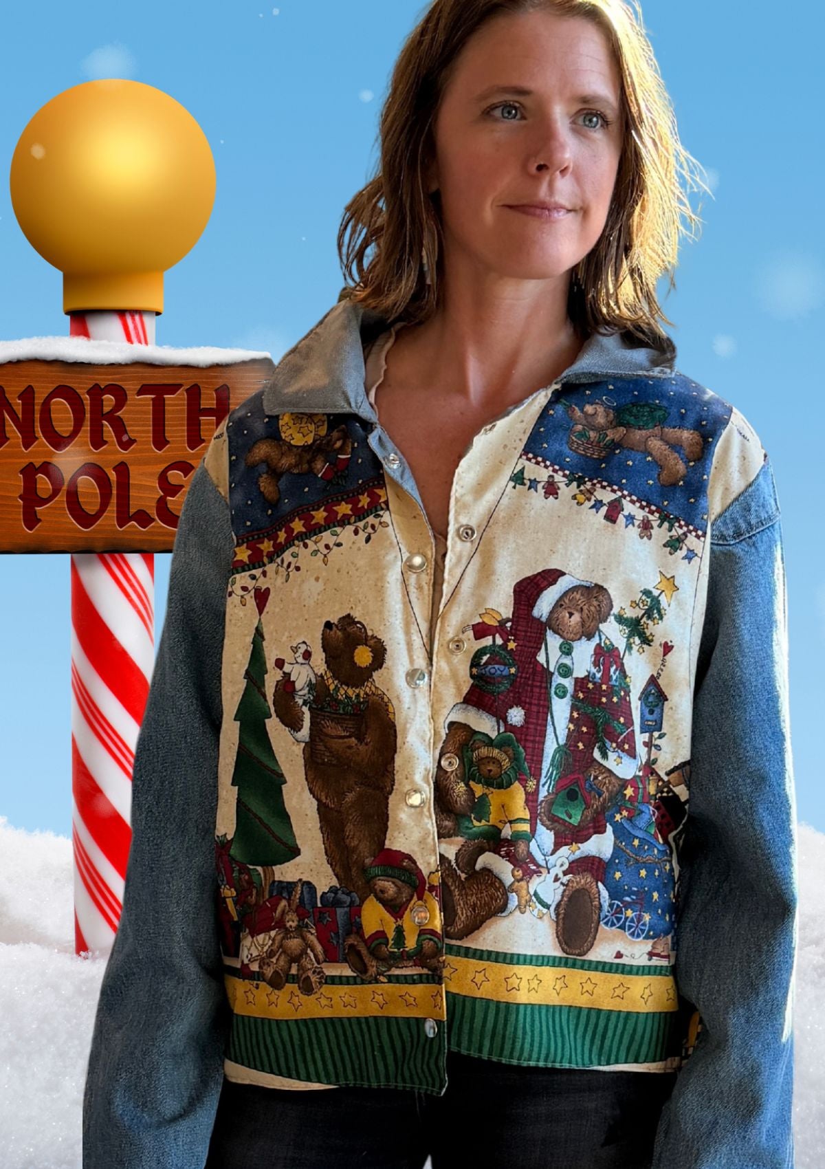 Person wearing a festive jacket with Christmas-themed designs upcycled from vintage fabric and denim jeans as sleeves against a snowy background with candy cane and 'North Pole' sign.