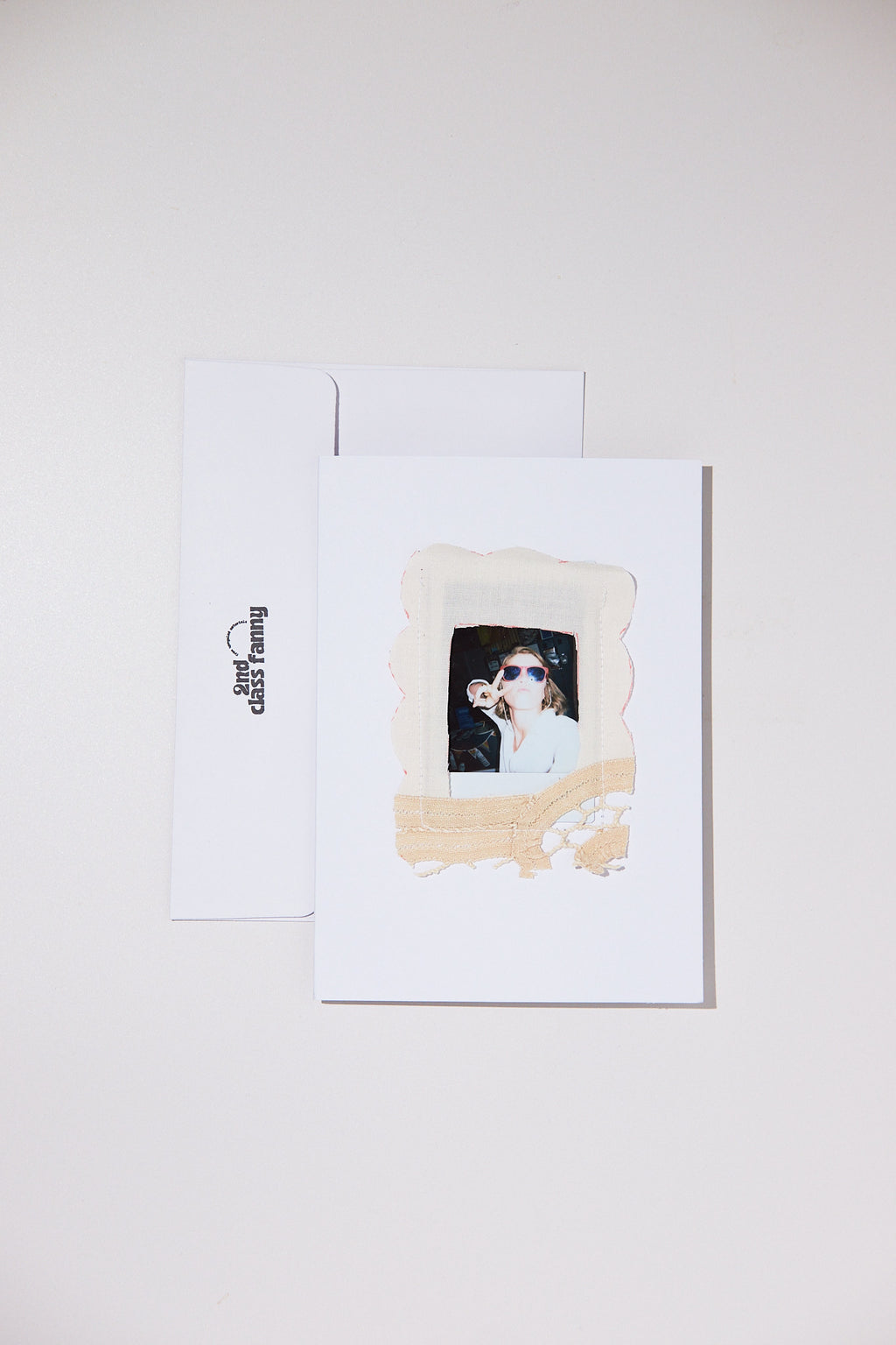 White card with envelope featuring an opening for your own Polaroid with a lace frame from upcycled lace curtains.