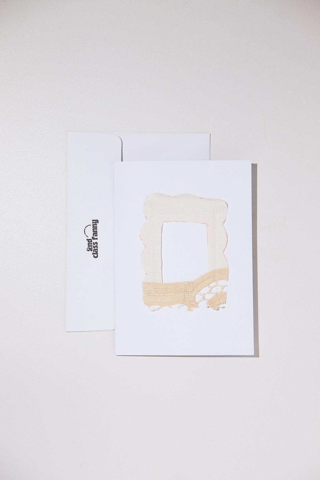 White card with envelope featuring an opening for your own Polaroid with a lace frame from upcycled lace curtains.