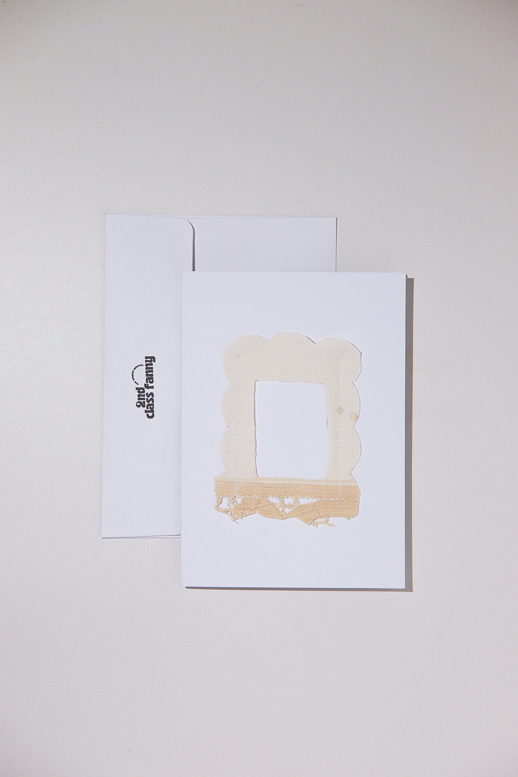 White card with envelope featuring an opening for your own Polaroid with a lace frame from upcycled lace curtains.