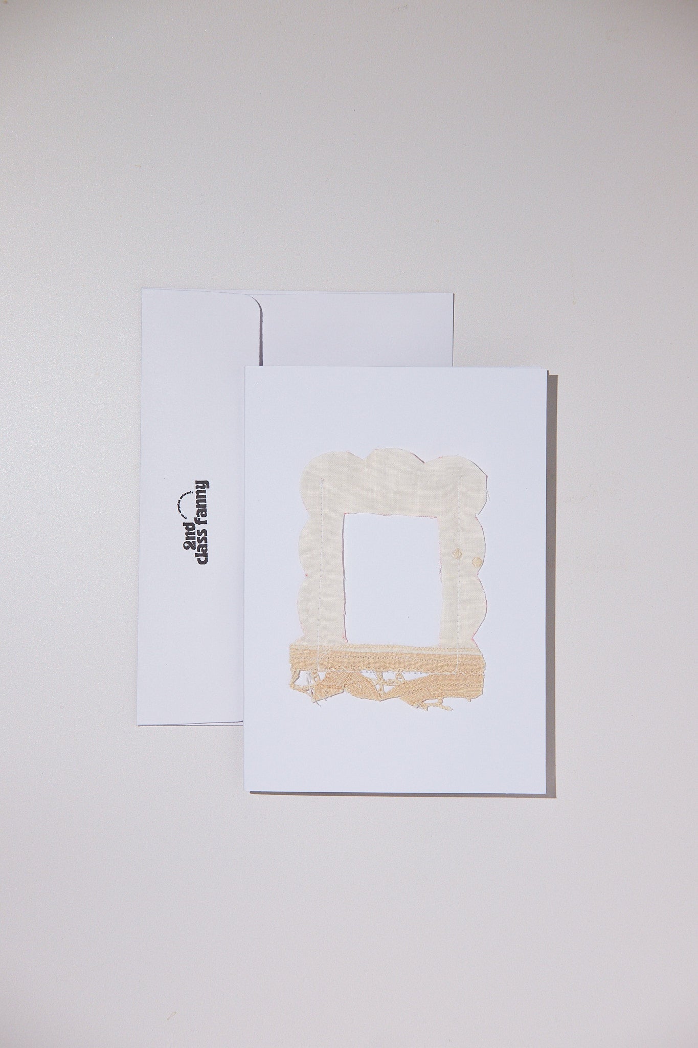 White card with envelope featuring an opening for your own Polaroid with a lace frame from upcycled lace curtains.