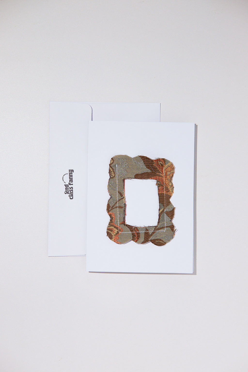 White card with envelope featuring an opening for your own Polaroid with a lace frame from upcycled curtains.