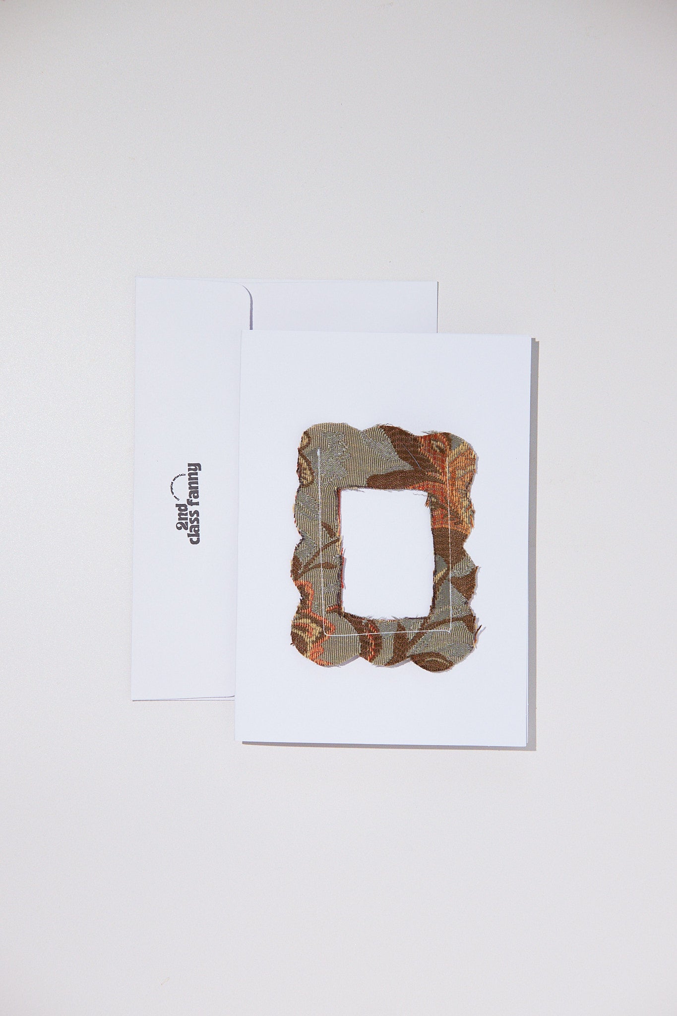 White card with envelope featuring an opening for your own Polaroid with a lace frame from upcycled curtains.