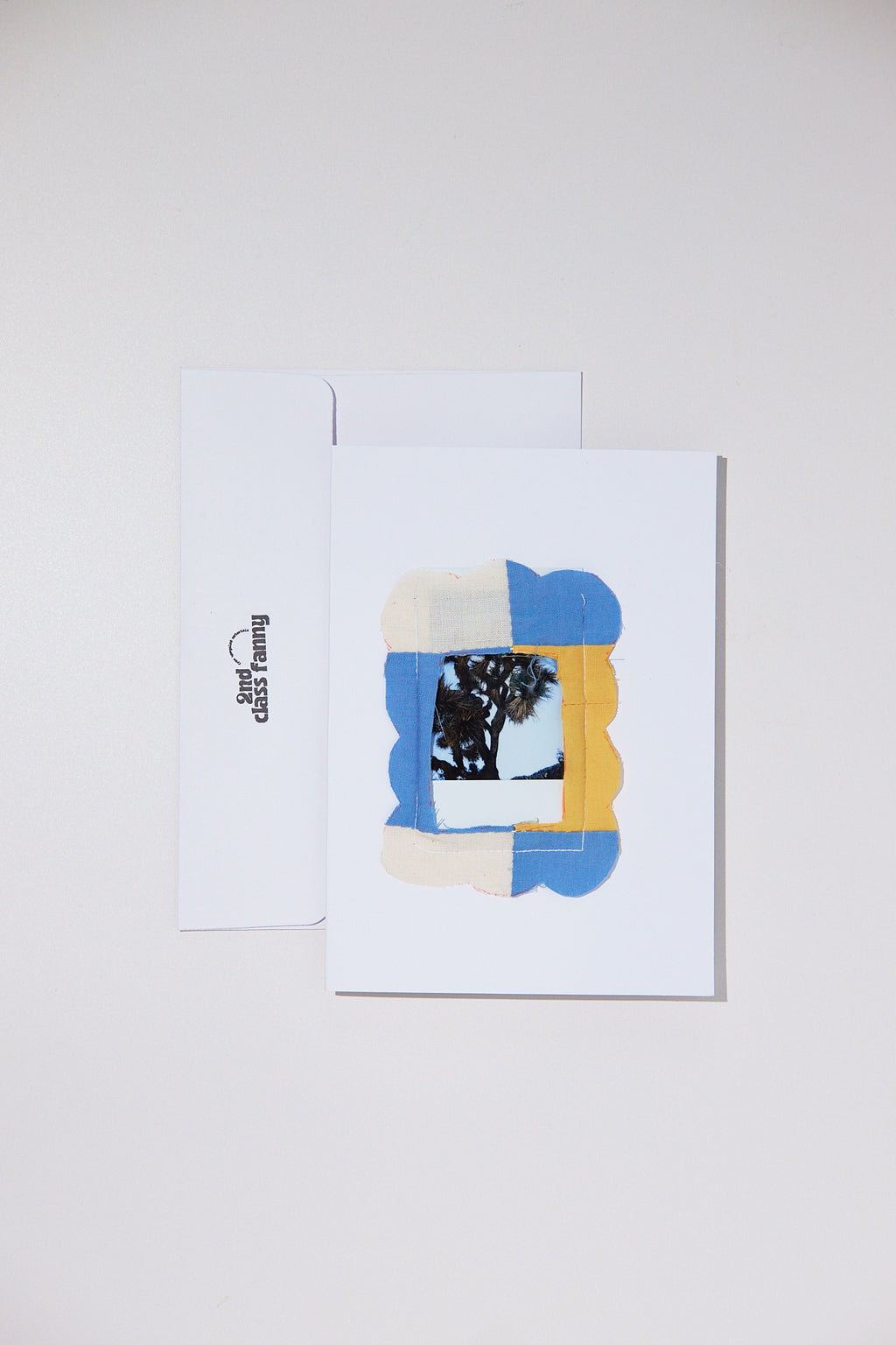 Greeting card with abstract design on a white background featuring an opening for your own Polaroid