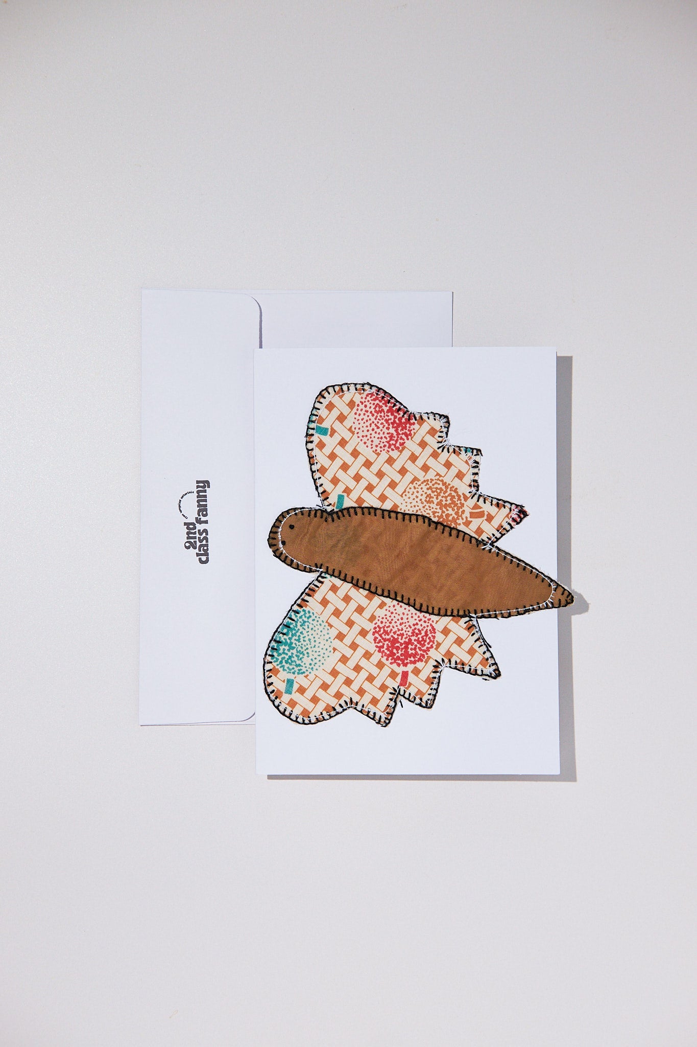 Butterfly-shaped patch on a white card with a plain background
