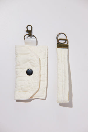 Quilted key cases with keychains upcycled from a quilt on a white background