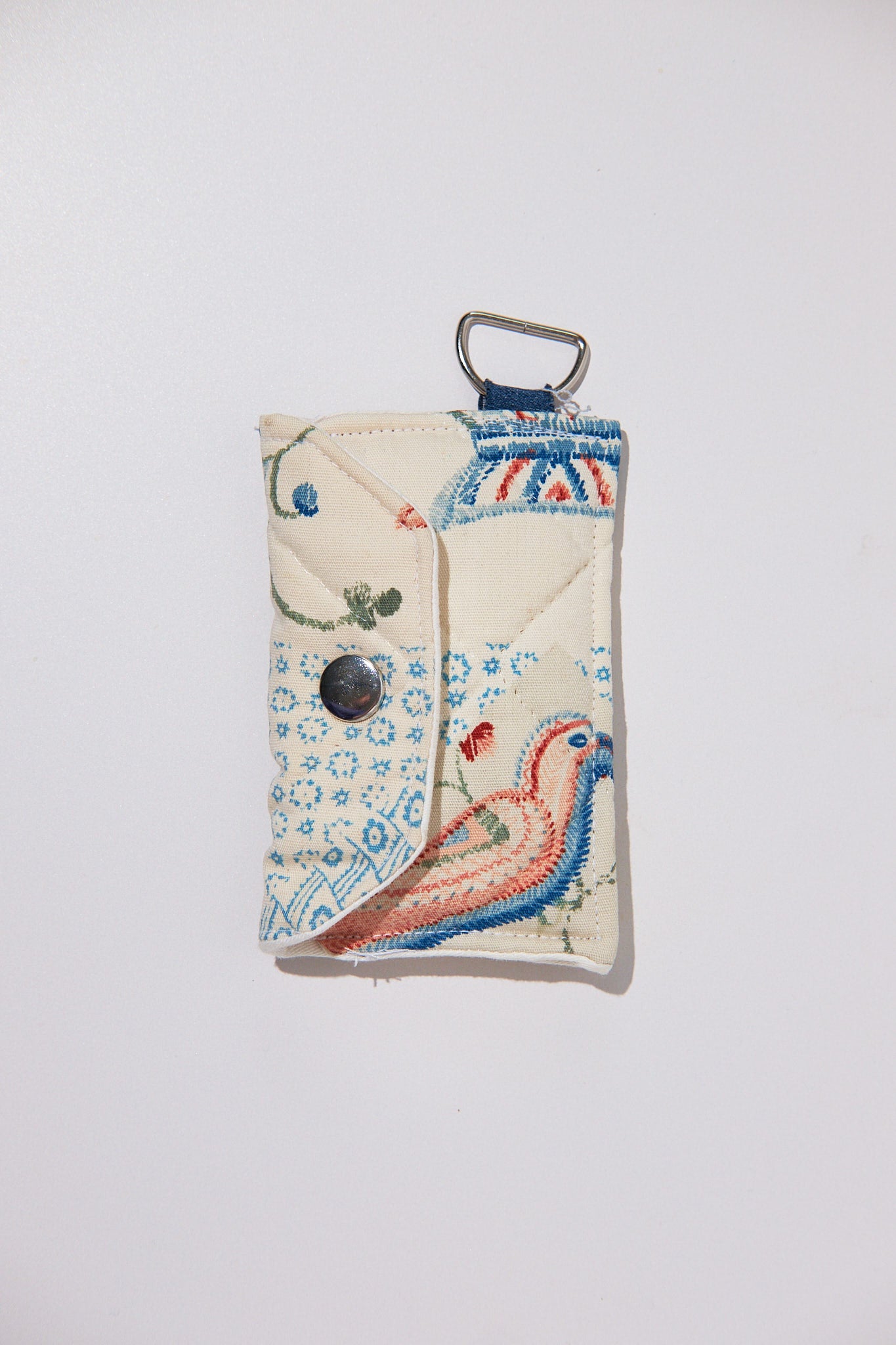 Quilted ID case with a bird design upcycled from a quilt on a white background
