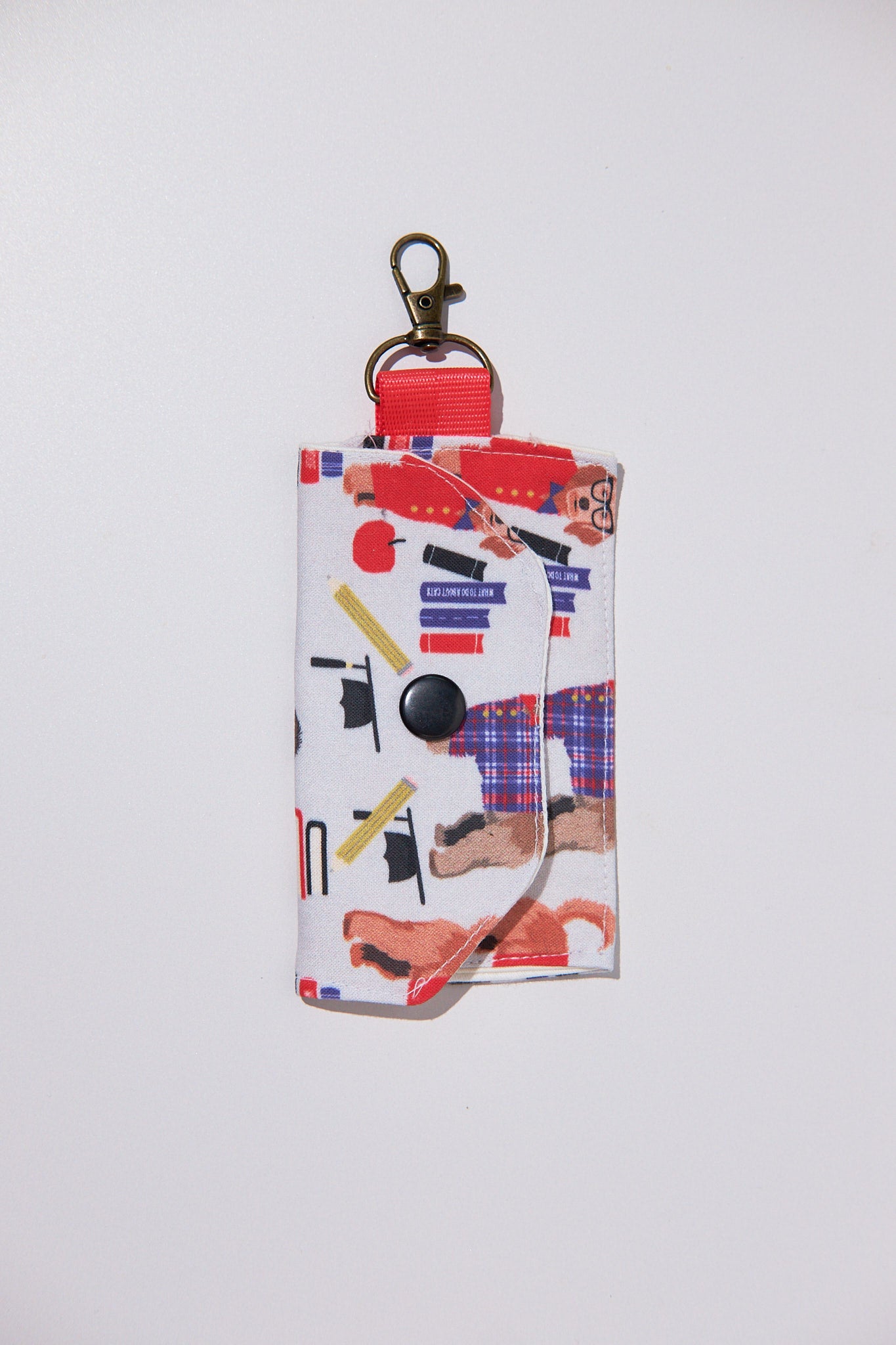 Keychain pouch with colorful design upcycled from a bedsheet on a white background