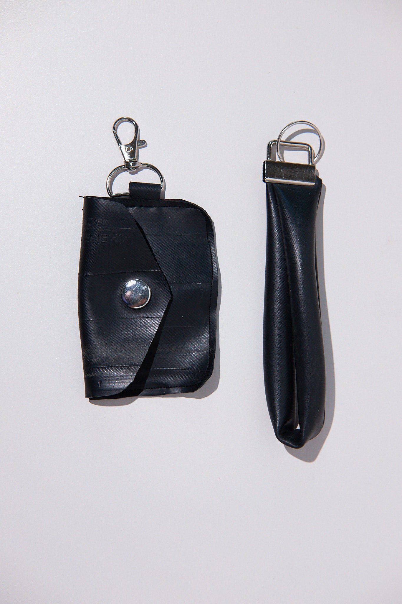 Black key case and keychain upcycled from a bike inner tube on a white background