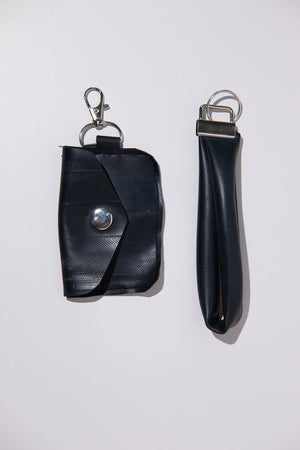Black key case and keychain upcycled from a bike inner tube on a white background