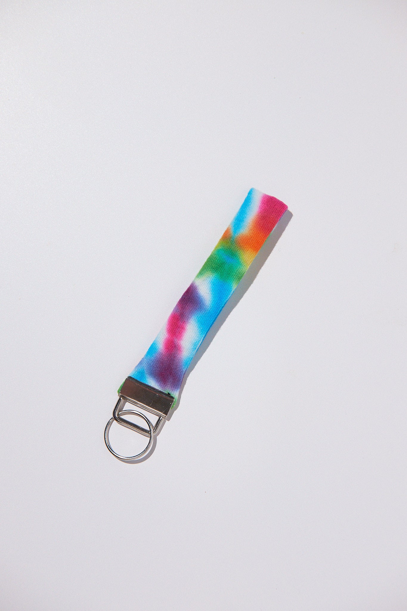 Colorful tie-dye keychain upcycled from a shirt on a white background