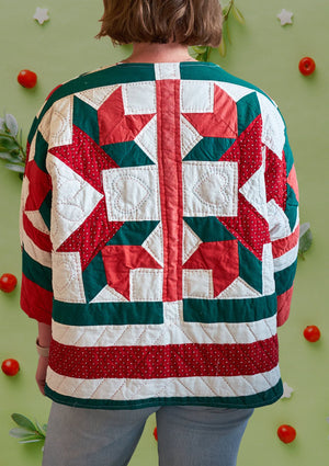 back of woman wearing green, red and white quilted shirt