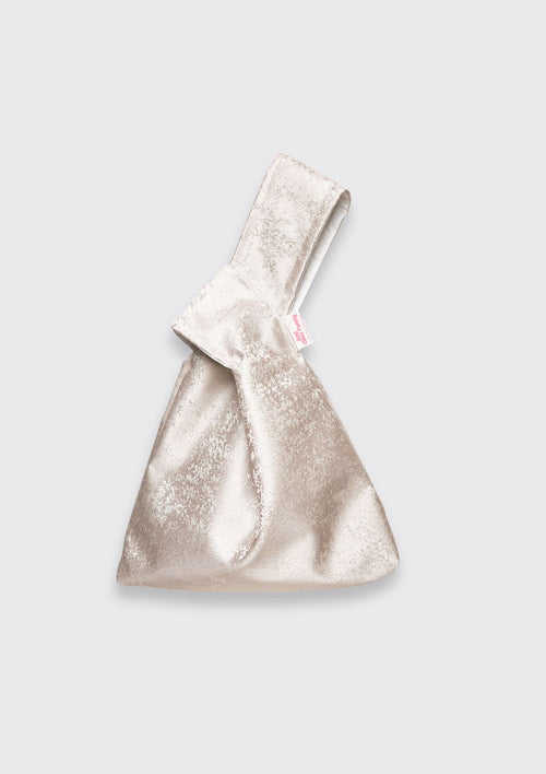 Silver handbag upcycled from deadstock fabric on a white background